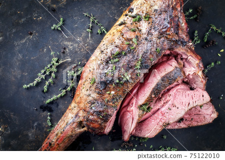 Traditional barbecue aged leg of venison sliced with herbs Traditional barbecue aged leg of venison sliced with herbs 75122010