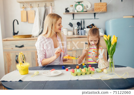 Mother with little daughter in a kitchen Mother with little daughter in a kitchen 75122060