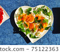 Boiled egg and parsley on a heart shaped plate 75122363