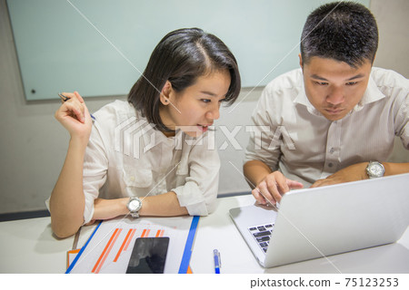 Two office employees working in a team Two office employees working in a team 75123253