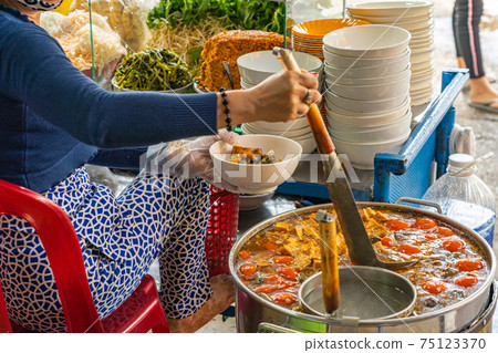 Woman cooking Vietnamese food- crab paste and snail noodle soup Woman cooking Vietnamese food- crab paste and snail noodle soup 75123370