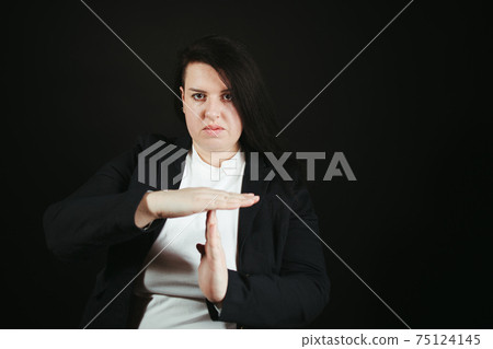 Confident woman showing T sign with hands Confident woman showing T sign with hands 75124145