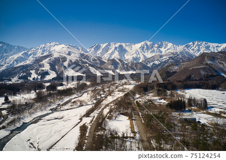 A magnificent view of Hakuba Sanzan and Happoone Ski Resort as seen from Matsukawa, Hakuba Village, Nagano Prefecture (aerial view by drone) A magnificent view of Hakuba Sanzan and Happoone Ski Resort as seen from Matsukawa, Hakuba Village, Nagano Prefecture (aerial view by drone) 75124254
