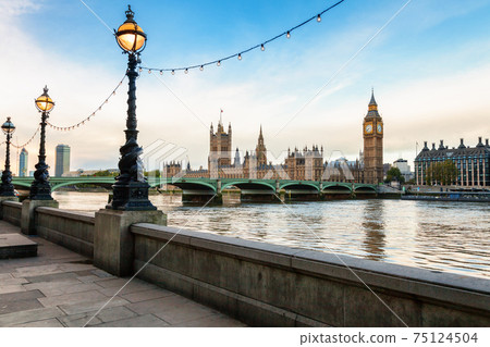 Dolphin lamp posts on the Queens Walk promenade on the southern bank of the River Thames in London England 75124504