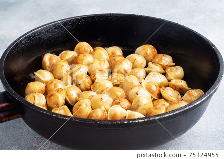 Delicious fried dumplings with meat in a pan. Delicious fried dumplings with meat in a pan. 75124955