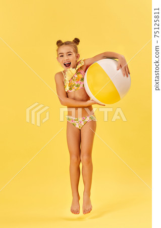 little child girl with colorful beach ball 75125811