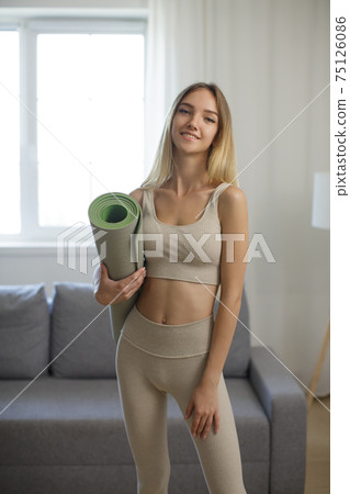Sporty Woman with Yoga Mat at Home Sporty Woman with Yoga Mat at Home 75126086