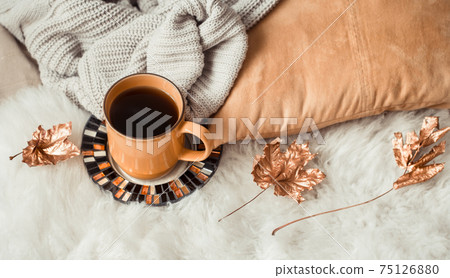 Still life Cup of tea with autumn leaves and sweater. Still life Cup of tea with autumn leaves and sweater. 75126880