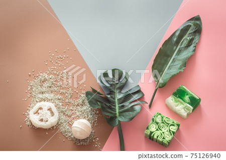 Spa composition with body care items on a colored background. 75126940