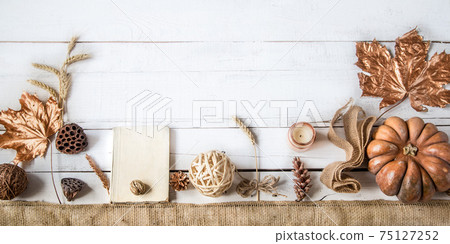Autumn background with decorative items and pumpkin. 75127252