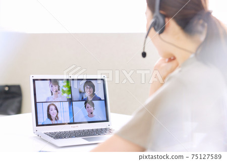 Woman having a web conference in the office Woman having a web conference in the office 75127589