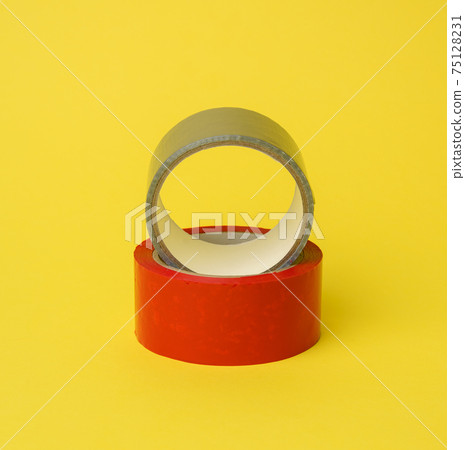 red and gray scotch tape isolated on a yellow background 75128231