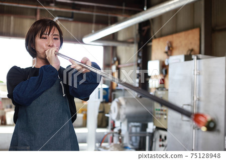 Woman making a glass container Blown glass 75128948