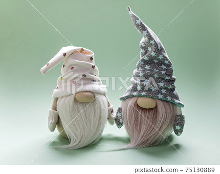 Cute bearded gnome in a cap on a light green background. Handmade soft toy. Home decor 75130889