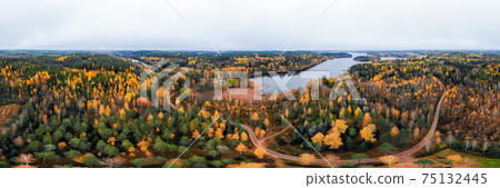 Panoramic aerial view of lake and colorful forests on a autumn day in Finland. Drone photography 75132445
