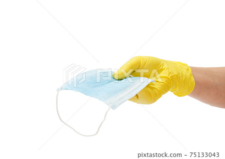 Female doctor in a glove holding a medical mask in his hand. Female doctor in a glove holding a medical mask in his hand. 75133043