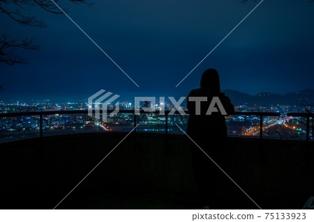 She looking at the night view 75133923