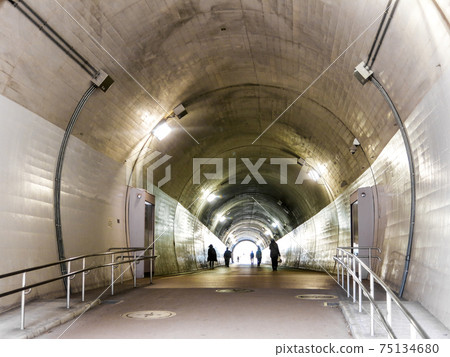 Silhouette of people walking in the tunnel Silhouette of people walking in the tunnel 75134680