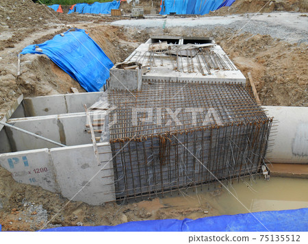 JOHOR, MALAYSIA -JANUARY 12, 2017: Underground onsite detention pond under construction at the construction site. It is using precast concrete U channel box culvert as the main structure. JOHOR, MALAYSIA -JANUARY 12, 2017: Underground onsite detention pond under construction at the construction site. It is using precast concrete U channel box culvert as the main structure. 75135512