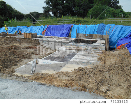 JOHOR, MALAYSIA -JANUARY 12, 2017: Underground onsite detention pond under construction at the construction site.  It is using precast concrete U channel box culvert as the main structure.  75135515