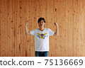 Man wearing Virgin Islands flag color of shirt and standing with raised both fist 75136669
