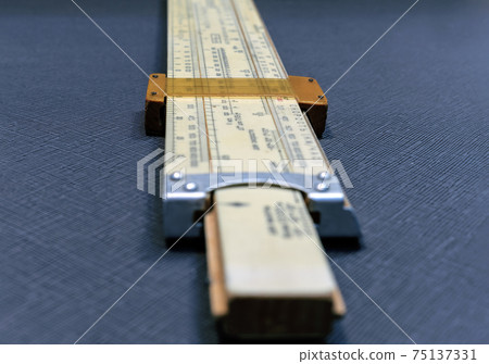 Vintage equipments for air navigation: pilot`s slide rule, area sketch, compasses & etc. Translation of signs on slide rule are: `velocity, air speed, distance, flight level, air temperature`. 75137331
