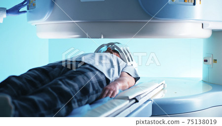 Crop doctor in gloves turning on MRI scanner for senior man 75138019