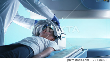 Crop doctor in gloves starting MRI scanning of kid 75138022