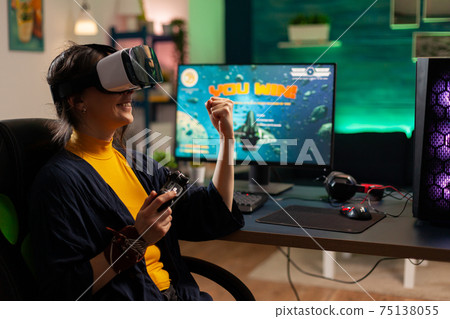 Winner player holding console playing virtual reality videogame Winner player holding console playing virtual reality videogame 75138055