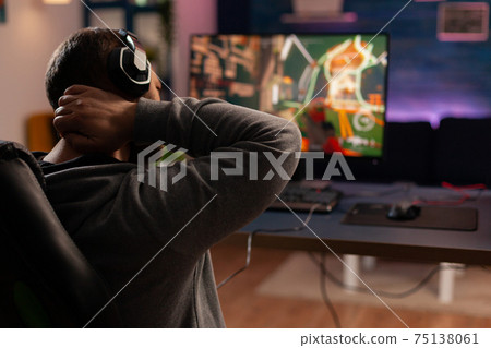 Professional player playing shooter videogame Professional player playing shooter videogame 75138061