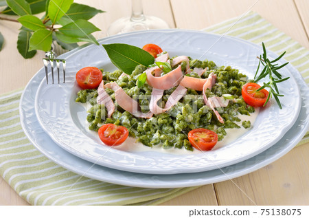 South Tyrolean spinach spaetzle with parmesan cream sauce, strips of ham and fried tomatoes South Tyrolean spinach spaetzle with parmesan cream sauce, strips of ham and fried tomatoes 75138075