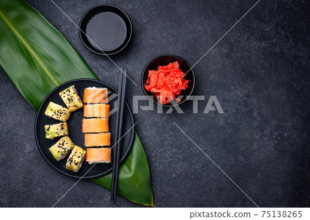 Traditional Japanese sushi rolls on dark background Traditional Japanese sushi rolls on dark background 75138265