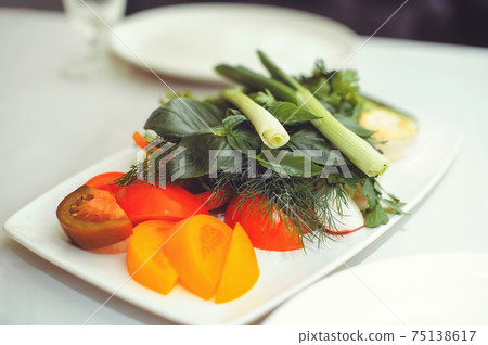 Fresh vegetable salad with radish, cucumber, bell pepper, tomatoes and herbs in a ceramic bowl restaurant dish. Selective focus Fresh vegetable salad with radish, cucumber, bell pepper, tomatoes and herbs in a ceramic bowl restaurant dish. Selective focus 75138617