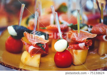 A set of beautiful canapes on golden dishes. Buffet table. Food. Fun. Close-up 75138624