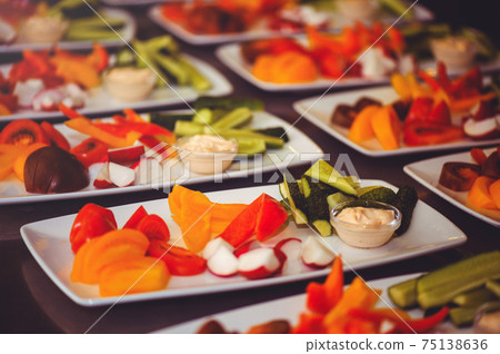 Fresh vegetable salad with radish, cucumber, bell pepper, tomatoes and herbs in a ceramic bowl restaurant dish. Selective focus 75138636