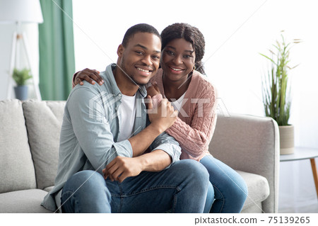 Beautiful black couple spending time together at home Beautiful black couple spending time together at home 75139265