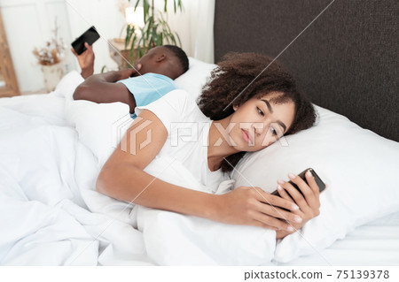 Day off in bed, gadget addiction and couple problems due social media online Day off in bed, gadget addiction and couple problems due social media online 75139378
