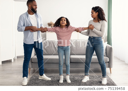 Divorce. Angry African American parents fighting over their child 75139458