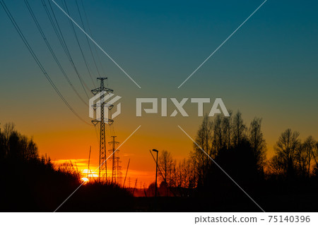 High voltage towers aganist the beautiful sunset 75140396