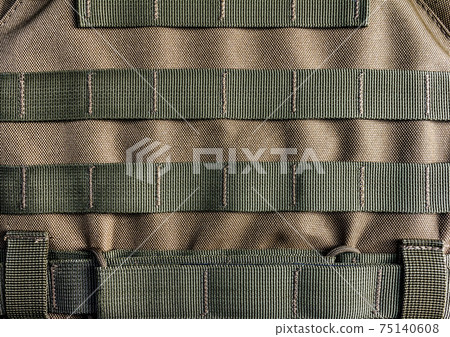 Photo of a military armor vest molle system closeup view. Photo of a military armor vest molle system closeup view. 75140608