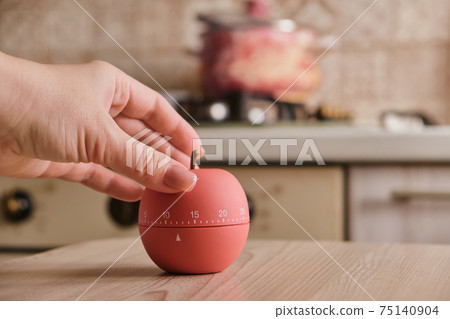 modern kitchen timer apple shaped on the background of the kitchen modern kitchen timer apple shaped on the background of the kitchen 75140904