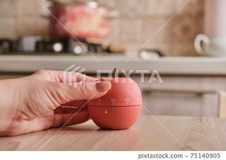 modern kitchen timer apple shaped on the background of the kitchen 75140905