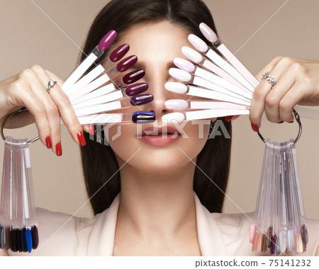 Manicurist in working form with tools in hand. Nail photo content Manicurist in working form with tools in hand. Nail photo content 75141232