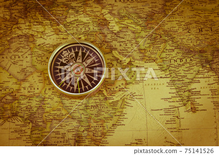 Compass on a vintage world map. Retro style Compass on a vintage world map. Retro style 75141526