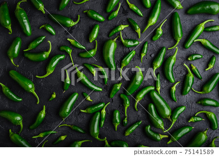 Composition of Jalapeno Peppers on Concrete Background 75141589