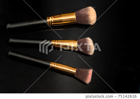 Makeup brushes on black background. Close up of makeup brushes set 75142616