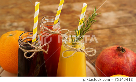 Home made lemonade in little bottles. Multicolored juices and fruits 75143418