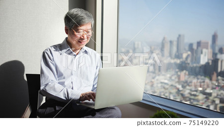 man use laptop near window man use laptop near window 75149220