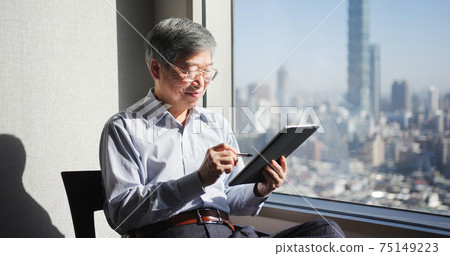 man use tablet near window man use tablet near window 75149223