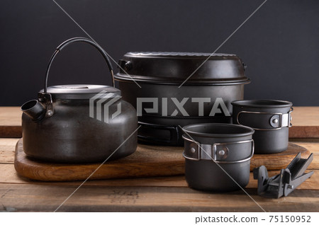 A set of tourist utensils for hiking in nature. A pot and kettle for tourism. 75150952